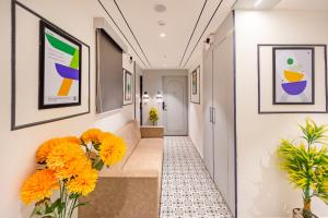 a corridor with flowers in a hallway at Treebo Arizona in Gandhinagar