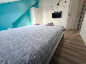 a bedroom with a bed and a tv on a wall at Apartment Juliet in Izola