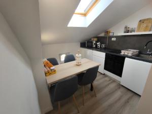a small kitchen with a wooden table and chairs at Apartment Juliet in Izola +10 photos