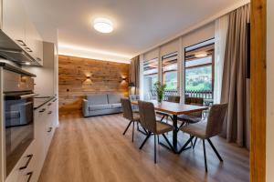 a kitchen and dining room with a table and chairs at Adler Resort in Saalbach-Hinterglemm +201 photos