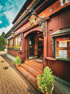 an entrance to a restaurant with stairs leading to the door at Hotel Zur Erholung in Braunlage