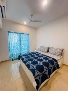 a bedroom with a large bed and a window at Serene white studio - 2nd floor in Dehu Road +34 photos