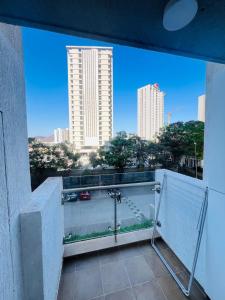 a balcony with a view of a city skyline at Serene white studio - 2nd floor in Dehu Road