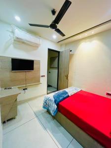 a bedroom with a bed and a flat screen tv at Hotel Dream Stay in Pānīpat