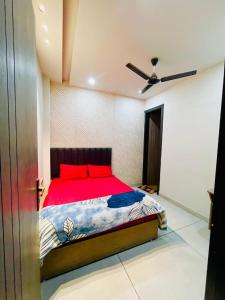 a bedroom with a bed and a ceiling fan at Hotel Dream Stay in Pānīpat +3 photos
