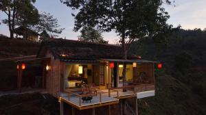 a small house with a porch and a deck at Chang'E Villa Rakthai in Ban Rak Thai
