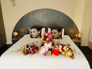 a bed with flowers and pictures of two men at Casa De Montague in Noordheuwel