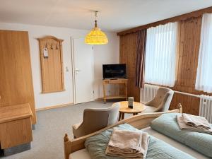 a living room with a bed and a table at Hotel Zur Erholung in Braunlage