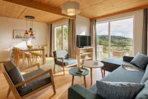 a living room with a couch and a table at Center Parcs Bostalsee Saarland in Nohfelden