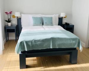 a bedroom with a large bed with two night stands at Hotel Eden Palace au Lac in Montreux