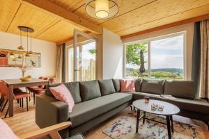 a living room with a couch and a table at Center Parcs Bostalsee Saarland in Nohfelden