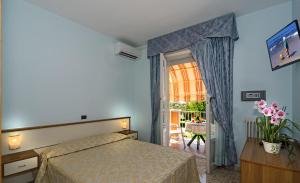 a bedroom with a bed and a window at Hotel Lido in Marina di Massa