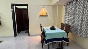 a dining room with a table and chairs and a window at Spacious 2BHK flat in new panvel in Navi Mumbai +28 photos