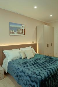 a bedroom with a bed with a blue blanket at Villa Enza B&B in Ginosa +108 photos