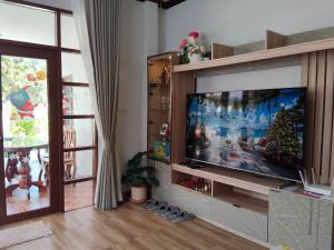 a living room with a large flat screen tv at Celine Pool Villa Cha-Am in Cha Am