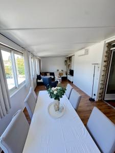 a living room with a white table and chairs at Large house with garden in Vulaines-sur-Seine