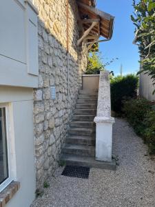 a set of stairs next to a stone building at Large house with garden in Vulaines-sur-Seine