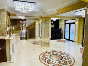 a large room with a lobby with a chandelier at Imperial Resort in Codlea