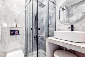 a bathroom with a sink and a shower at Однокомнатные и 2х комнатные квартиры на Туране in Taldykolʼ +102 photos