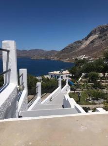 a view of a house with stairs leading to the water at Anemone Masouri in Masouri