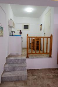 a room with stairs and a table and a kitchen at Anemone Masouri in Masouri +7 photos