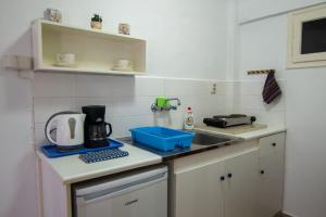 a kitchen counter with a sink and a microwave at Anemone Masouri in Masouri