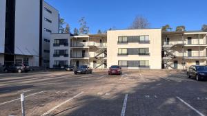 a parking lot with cars parked in front of a building at Best Rest Apartments in Narva-Jõesuu +7 photos