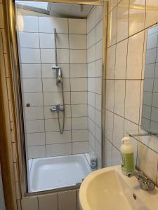 a bathroom with a shower and a sink and a tub at Deux chambres disponibles pour vous in Aalst