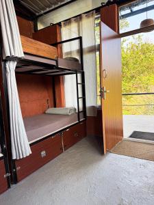 an open door to a bunk bed in a train car at Mad & Nomad Backpackers Hostel in Coonoor
