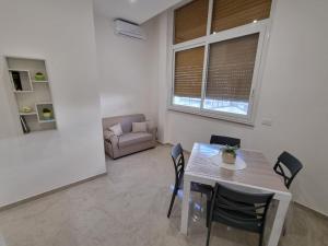 a living room with a table and chairs and a couch at ASTRA Guest House in Taranto +10 photos