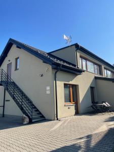 a house with a staircase on the side of it at Apartmány Holiday in Ostrava