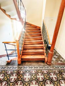 a staircase in a house with a rug at Historisches Altstadt-Juwel - Ruhige Top-Lage in Uninähe in Heidelberg +24 photos