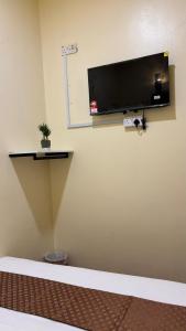 a wall with a flat screen tv on a wall at City Hub Hotel Sitiawan in Sitiawan +24 photos