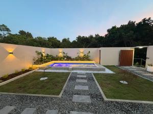 a backyard with a swimming pool and a garden at Siquijor Travellers Inn in Siquijor