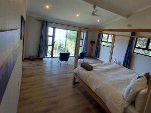 a bedroom with a bed and a large window at Villa Alba in Margate