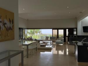 a living room with a couch and tables and chairs at Villa Aurora in Margate