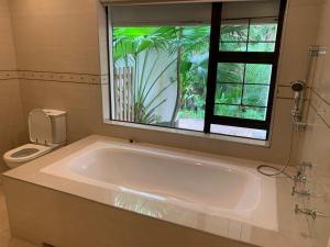 a large bath tub in a bathroom with a window at Villa Aurora in Margate +13 photos