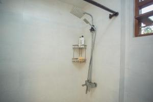a shower head on the wall of a bathroom at Serene Vista Villa, formerly Bungalows in Hikkaduwa