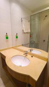a bathroom with a sink and a mirror at Terra Alta Suites in Salta +60 photos