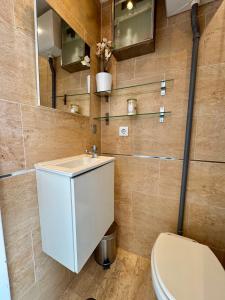 a bathroom with a toilet and a sink at Mini Estudio Málaga in Málaga +30 photos