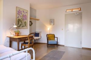 a bedroom with a desk and a bed and a table at Schloss Blumenfeld in Tengen
