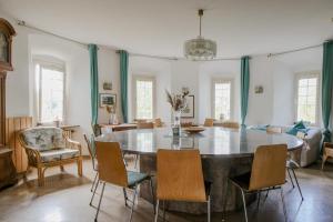 a living room with a large table and chairs at Schloss Blumenfeld in Tengen