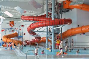 a large indoor water park with people playing in the water at Field View 162a fifth Ave in Bridlington
