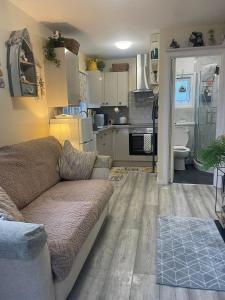 a living room with a couch and a kitchen at Field View 162a fifth Ave in Bridlington