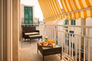 a balcony with a tray of fruit on a table at Floral Holiday in Minori