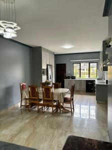 a kitchen and dining room with a table and chairs at Crompton Gardens 786 in Durban