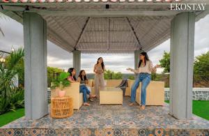 a group of women standing under a gazebo at Ekostay Cliffside Villa I Mountain View in Lonavala