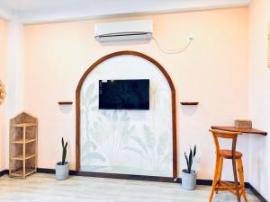an arched window in a room with plants at GreenKey Hotel & Resturent in Tanamalwila