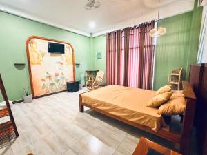 a bedroom with a bed and a painting on the wall at GreenKey Hotel & Resturent in Tanamalwila +67 photos