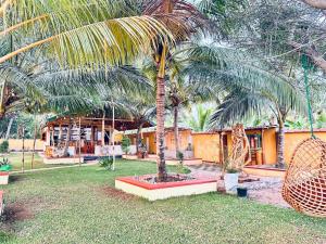 a palm tree in a yard next to a building at GreenKey Hotel & Resturent in Tanamalwila